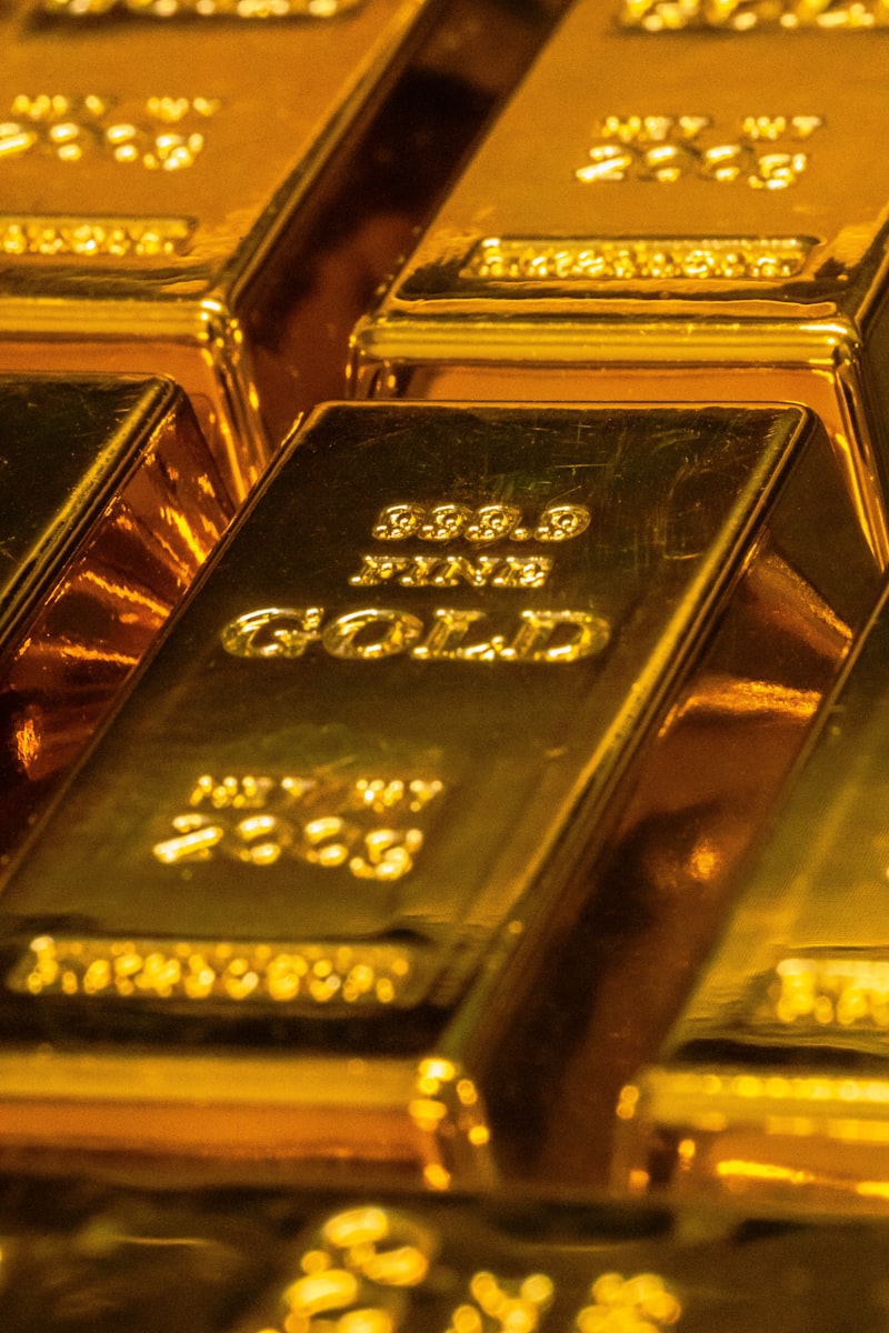 Close-up of a 999.9 fine gold bar showing weight and purity stamps